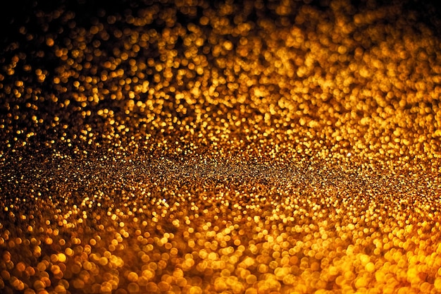 De focused, background of abstract glitter lights. blue, gold and black.