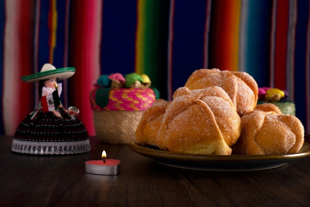 Dead bread and mexican handicrafts with colorful sarape in the background