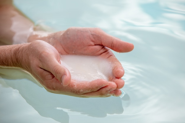 Dead Sea salt in male hands