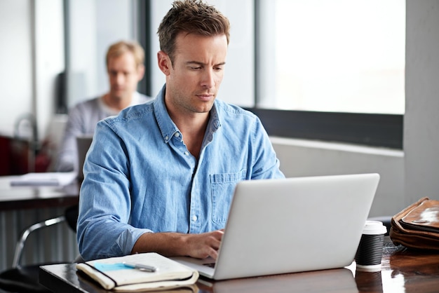 Deadlines are his inspiration Shot of a man working on a laptop in an office