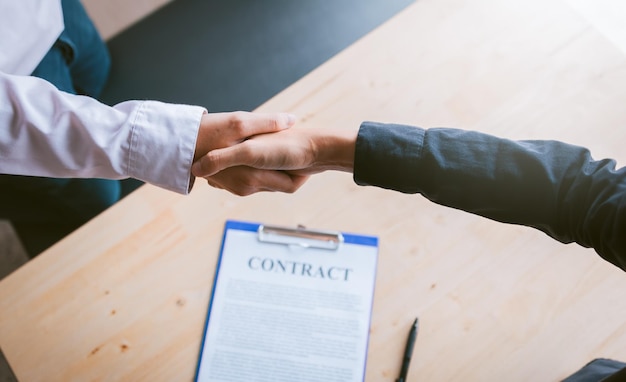 Dealer partnerships people shaking hands with making a contract in the office