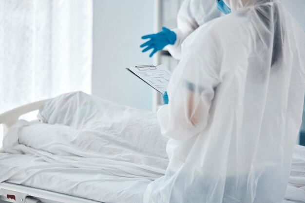 Photo death covid and doctors writing paper for patient in a bed at a hospital due to virus healthcare medical and clinic workers with communication report and help during health crisis in pandemic