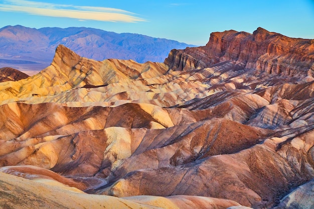 Death valley national park iconic sunrise at zabriskie point in desert mountains