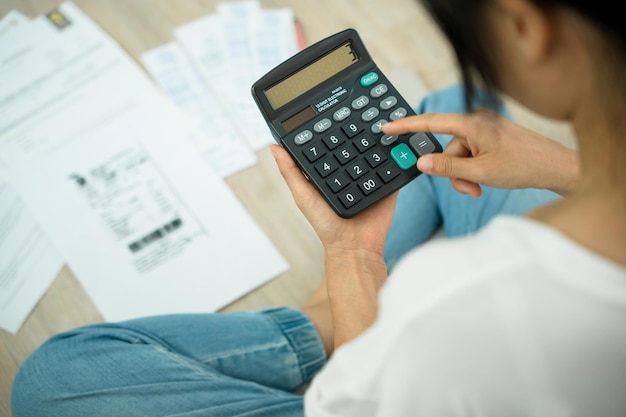 Debt Women calculate expenses with large bills Stressed housewife looking for a way to pay credit card bills