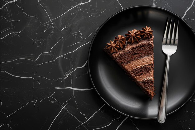 Photo decadent chocolate cake slice on black marble background