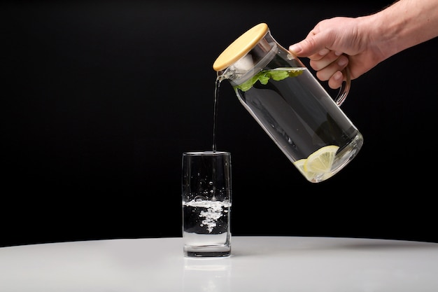 decanter with clean cool water with lemon and mint