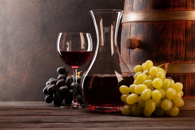 Decanterred wine grapes and old wooden barrel