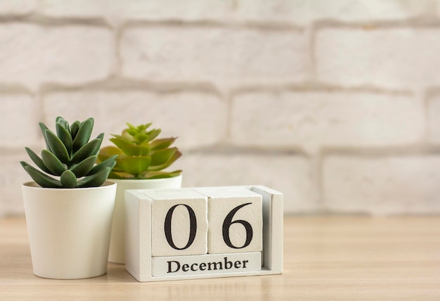 December 6 on the wooden calendar .Winter day, empty space for text.Calendar for December on a light background.