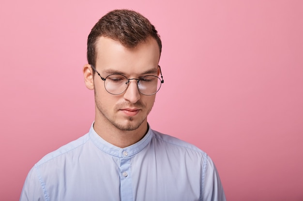 A decent young man in a sky blue shirt and computer glasses