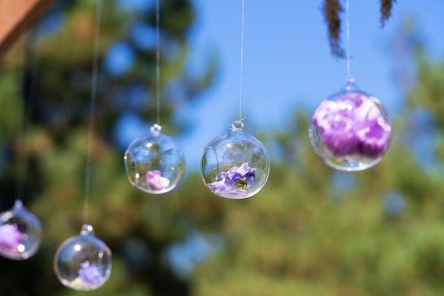 Decor details with fresh flowers. Flower buds in glass beads suspended in the air