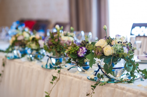 Decor of flowers on wedding table bride and groom