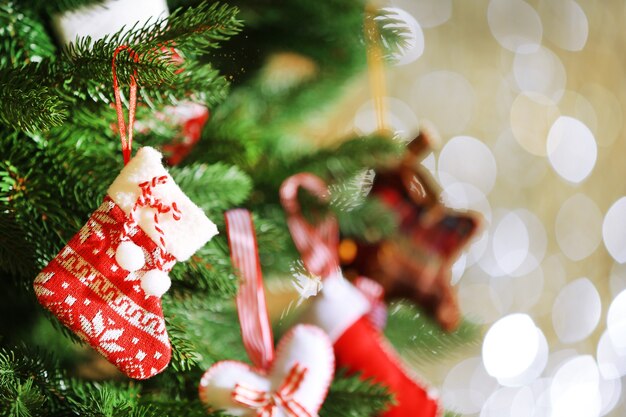 Decorated Christmas tree on blurred, sparkling and fairy surface