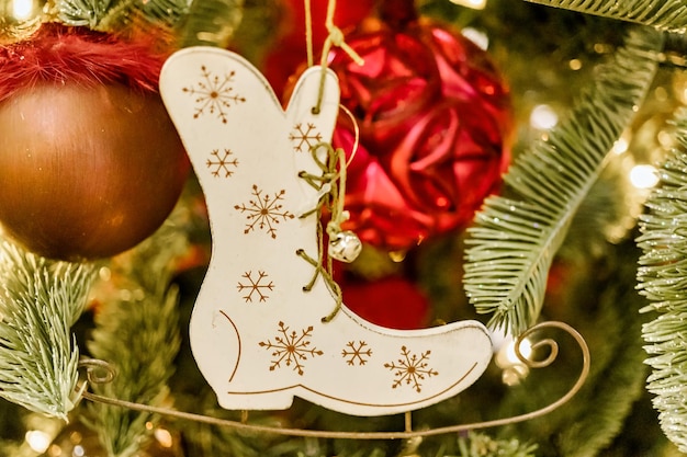 Decorated Christmas tree Christmas Eve christmas decorations new year Christmas tree toy in the form of a boot for gifts Selective focus Blurred background