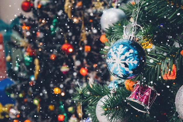 Decorated Christmas tree with colorful bauble on sparkling bokeh light blurred background