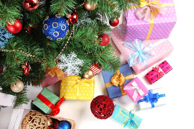 Decorated Christmas tree with gifts, close up,  isolated on white