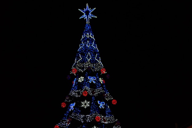 Decorated Christmas tree with multi-colored lights at night