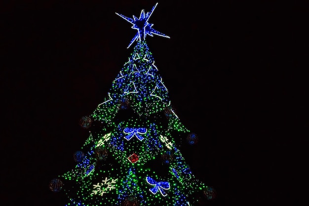 Decorated Christmas tree with multi-colored lights at night