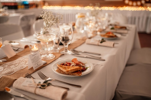 Decorated hall for wedding ceremony Wedding Banquet The chairs and round table for guests served with cutlery flowers