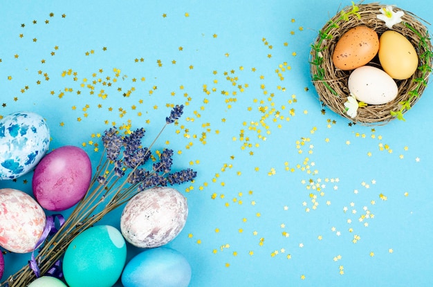 Decorated handmade Easter eggs for the holiday season on blue background. Creative minimal abstract  concept. Studio Photo