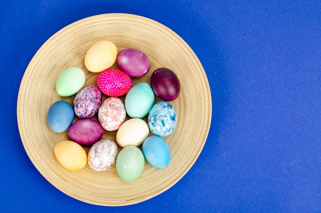 Decorated handmade Easter eggs for the holiday season on blue background. Creative minimal abstract  concept. Studio Photo