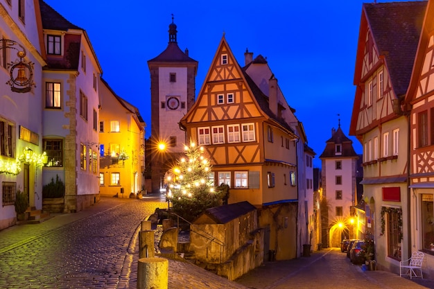 Decorated and illuminated Christmas street with gate and tower Plonlein in medieval Old Town of Rothenburg ob der Tauber, Bavaria, southern Germany