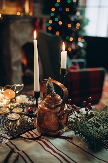 Decorated new years table with candles and antique teapot