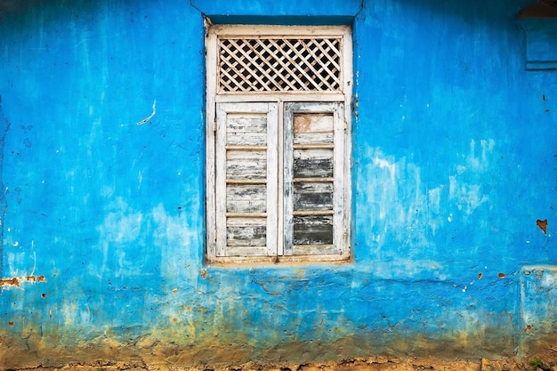 Decorated window on blue wall