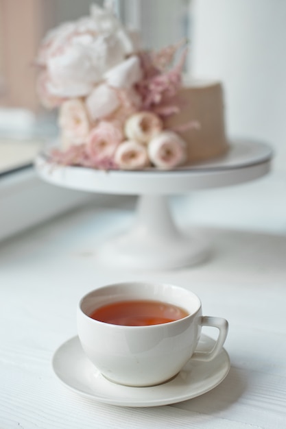 Decorated with fresh flowers, a white nude cake, a stylish cake