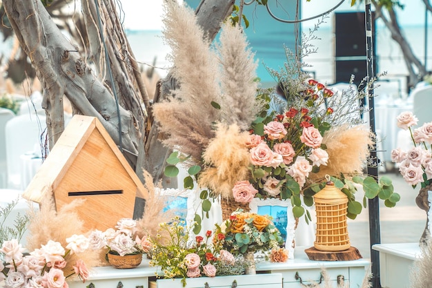 Decorating the arch with flowers and fabric for a wedding ceremony in nature Wedding Ceremony with flowers outside in the garden with hanging lights