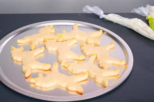 Decorating unicorn shaped sugar cookies with royal icing.