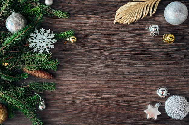 Decoration of Christmas Tree Green Branches on a Brown Background with Copy Space