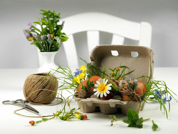 Decoration Easter eggs in ECOstyle with flowers and twine