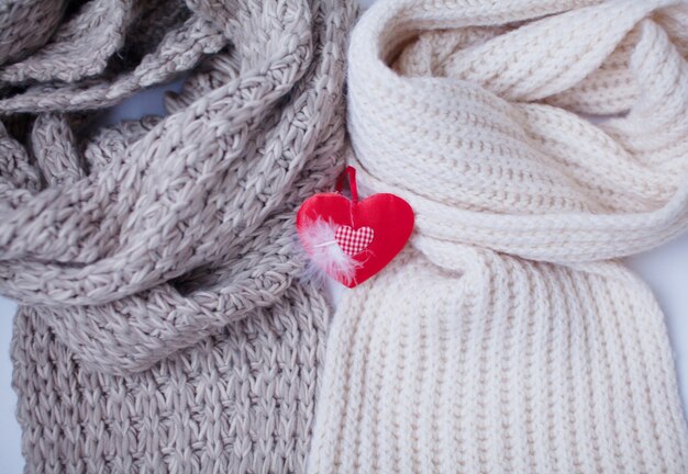 Decoration hearts on white woolen background.