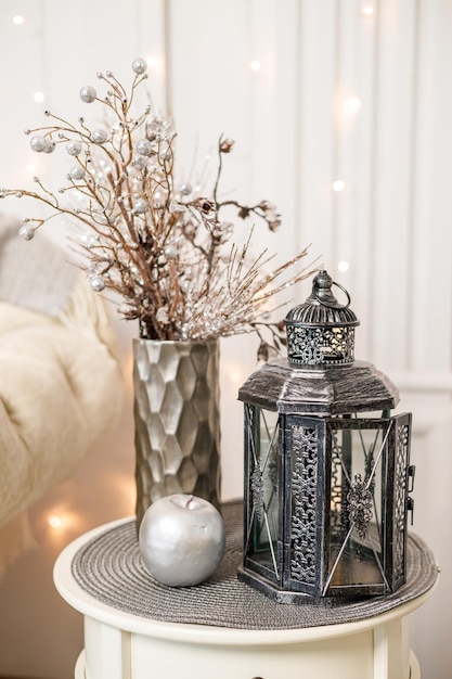 Decorative antique silver retro lamp on a white small table in the living room Interior decor in the house