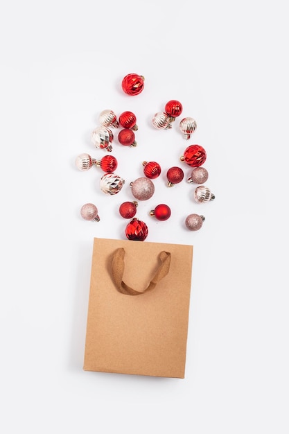 Decorative balls spilled from a craft gift bag on a white background Top view flat lay