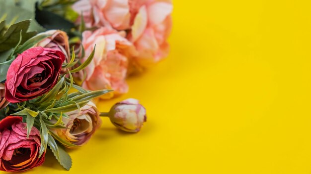 Decorative bouquet of peonies flowers on yellow background.