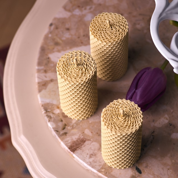 Decorative candles made of beeswax with a honey aroma for interior and tradition.