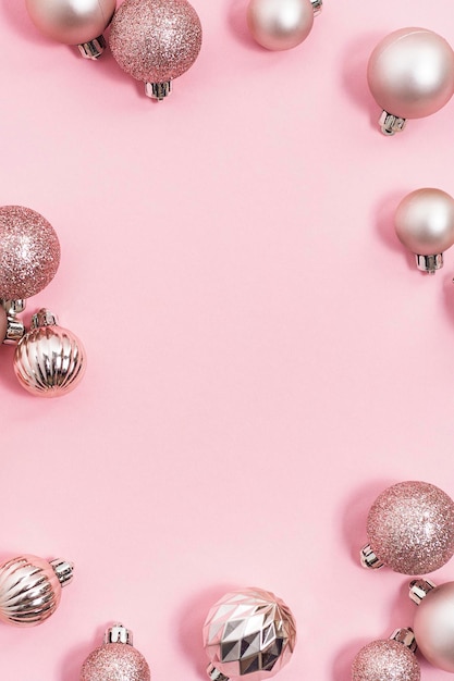 Decorative Christmas balls, empty space for text on a pink background. Top view, flat lay.