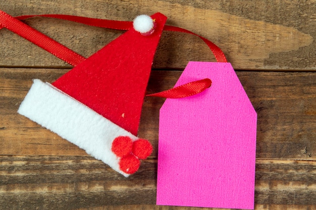 Decorative christmas elements next to card with red ribbon and space to write