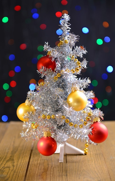 Decorative Christmas tree on table on bright background