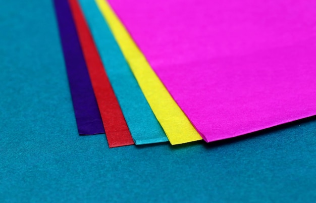 Decorative colored paper on green surface