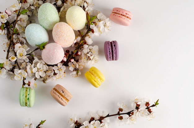 Decorative Easter eggs and sweet macarons or macaroons decorated 