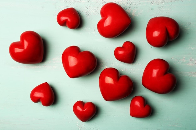 Decorative hearts on wooden background