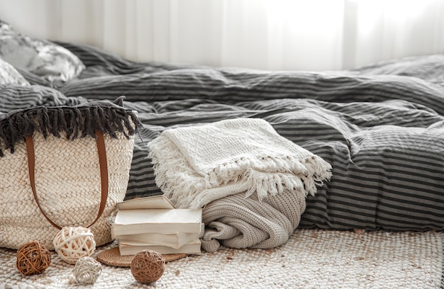 Decorative items in a cozy home interior with wicker straw large bag, and decorative elements.