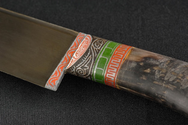 Decorative oriental knife on the black background Bone handle