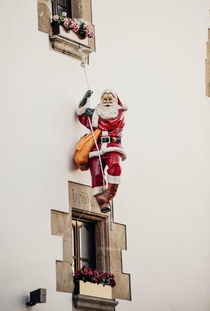 Decorative Santa Claus figure hanging from a facade