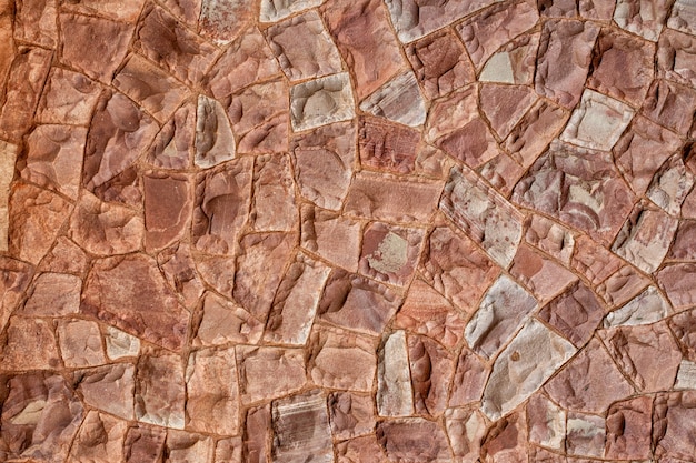 Decorative stone wall in pink tones background