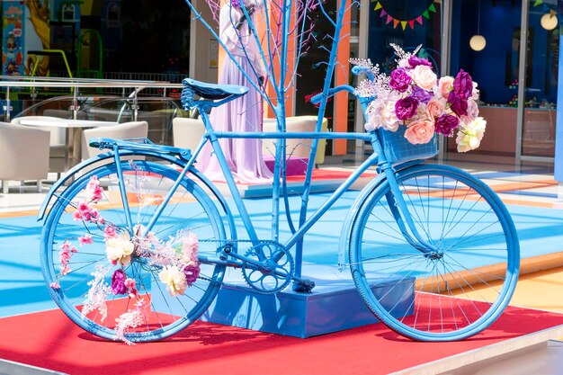 Decorative vintage blue bicycle with flowers