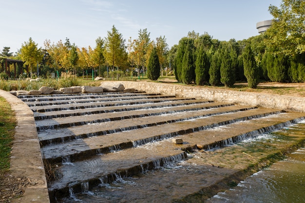 Decorative waterfall of natural stone in the form of steps