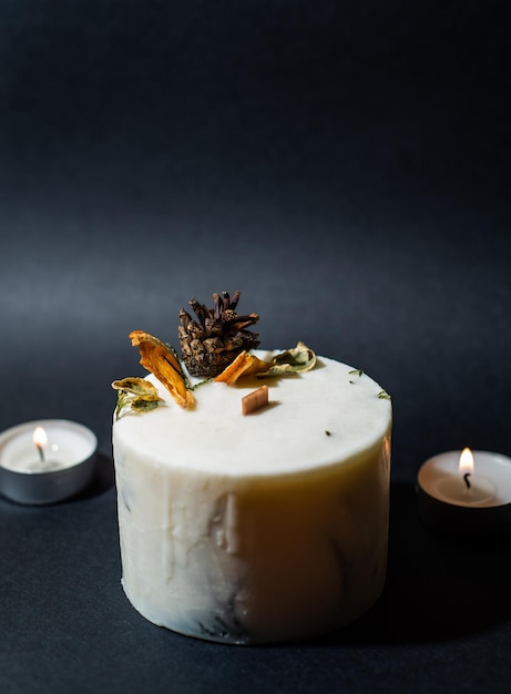 decorative wax candle and decorates with dried flowers, close-up